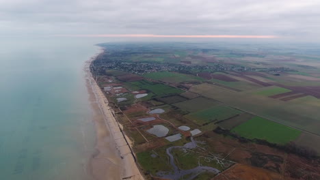 Normandy-beach-landscape-by-drone-fields-and-oyster-farm-cloudy-day